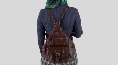 Woman wearing a leather sling strap backpack