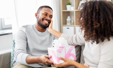 Woman giving man gift