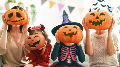 4 kids wearing pumpkin masks