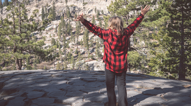 Woman wearing buffalo plaid in the forest