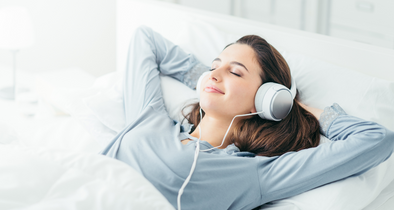 Woman laying down wearing headphones