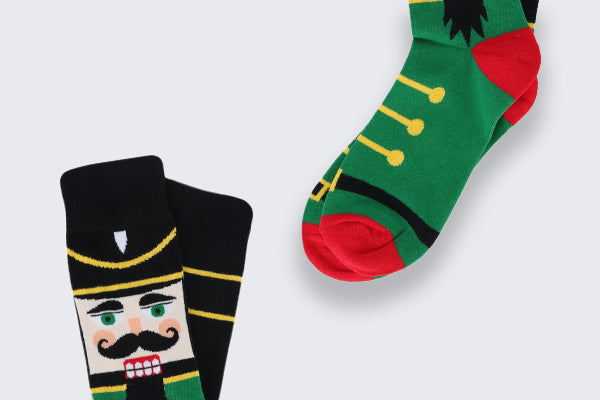 Two pairs of Holiday socks with nutcrackers