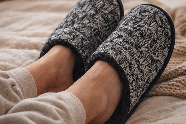 Man wearing slippers in bed